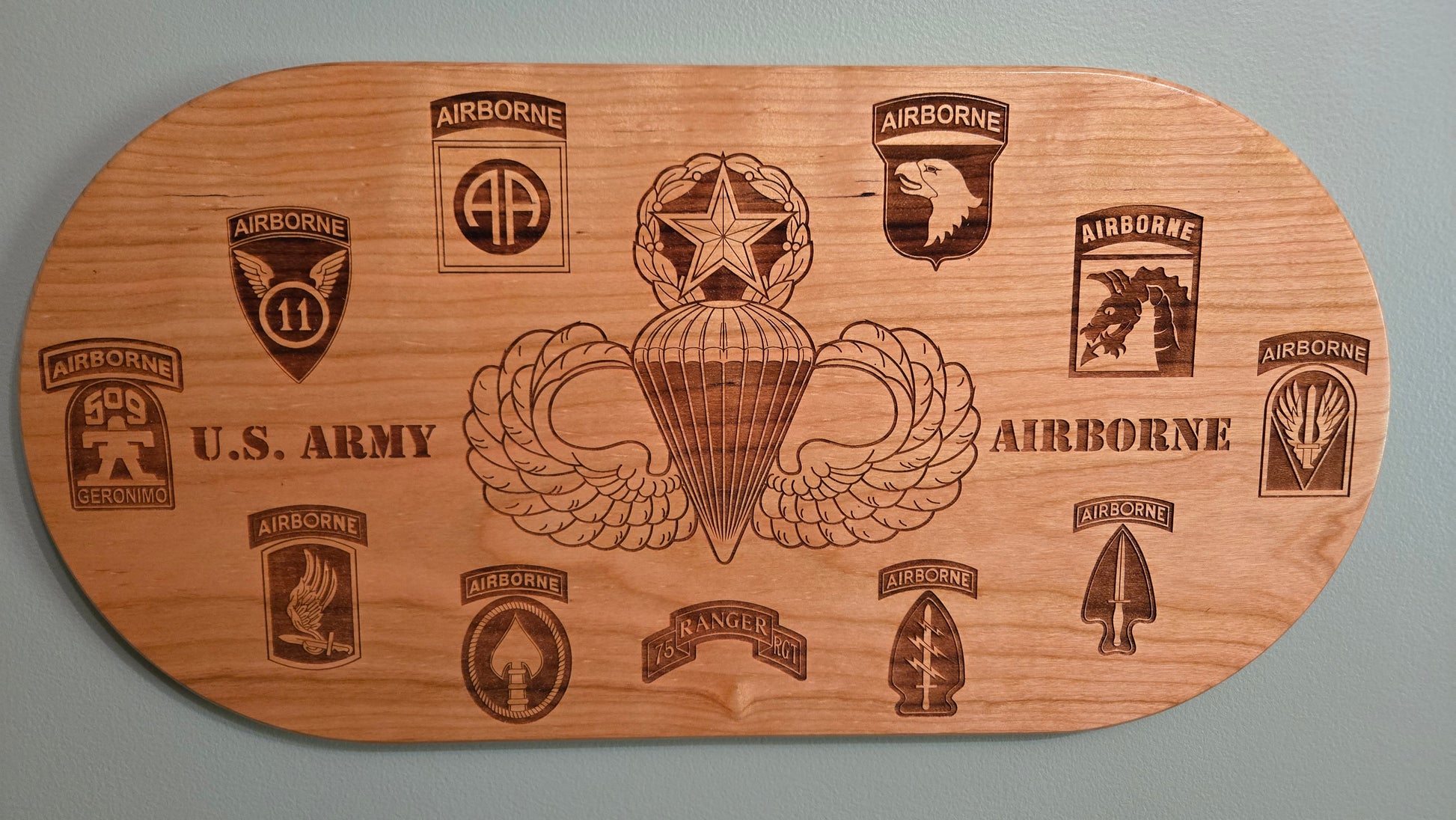 Solid cherry plaque with master parachutist wings and Army airborne unit patches.